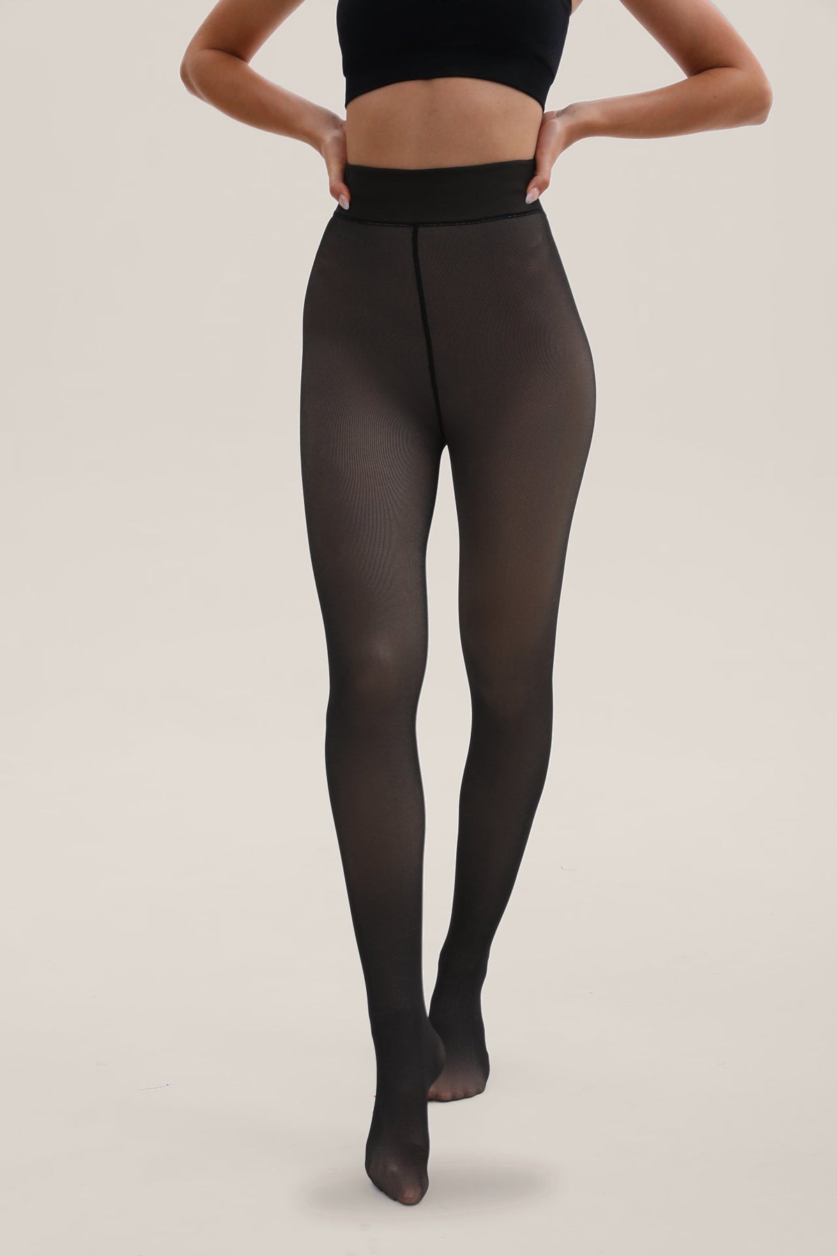 Woman wearing HONGTEYA black sheer illusion fleece-lined thermal tights