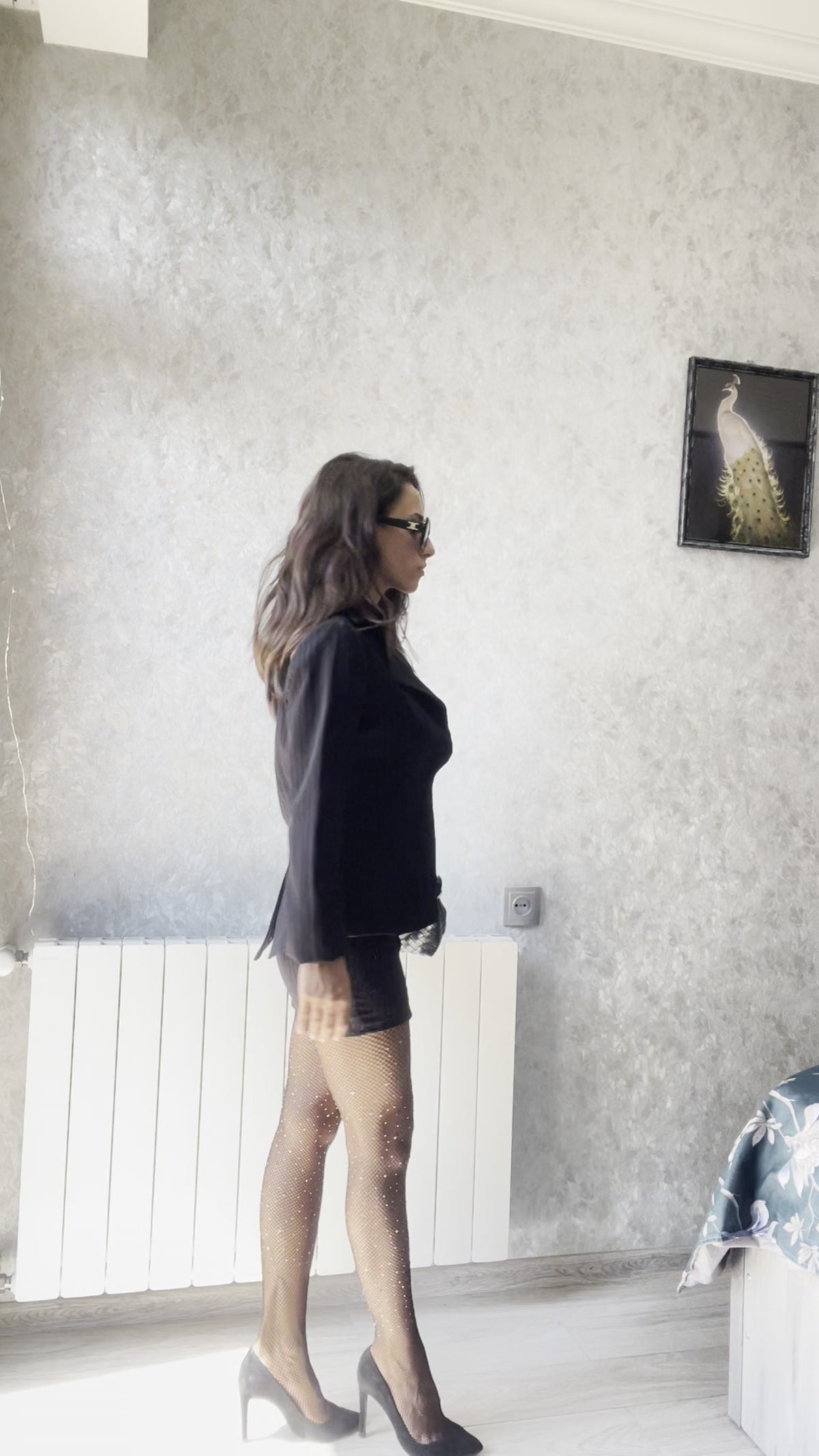 Woman wearing sparkling sheer tights with a black outfit