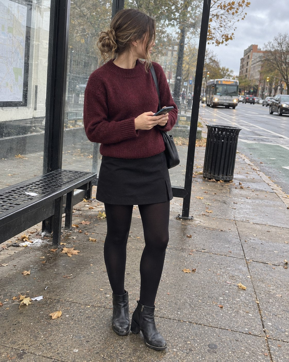 Customer wearing black opaque tights with a burgundy sweater at a city bus stop