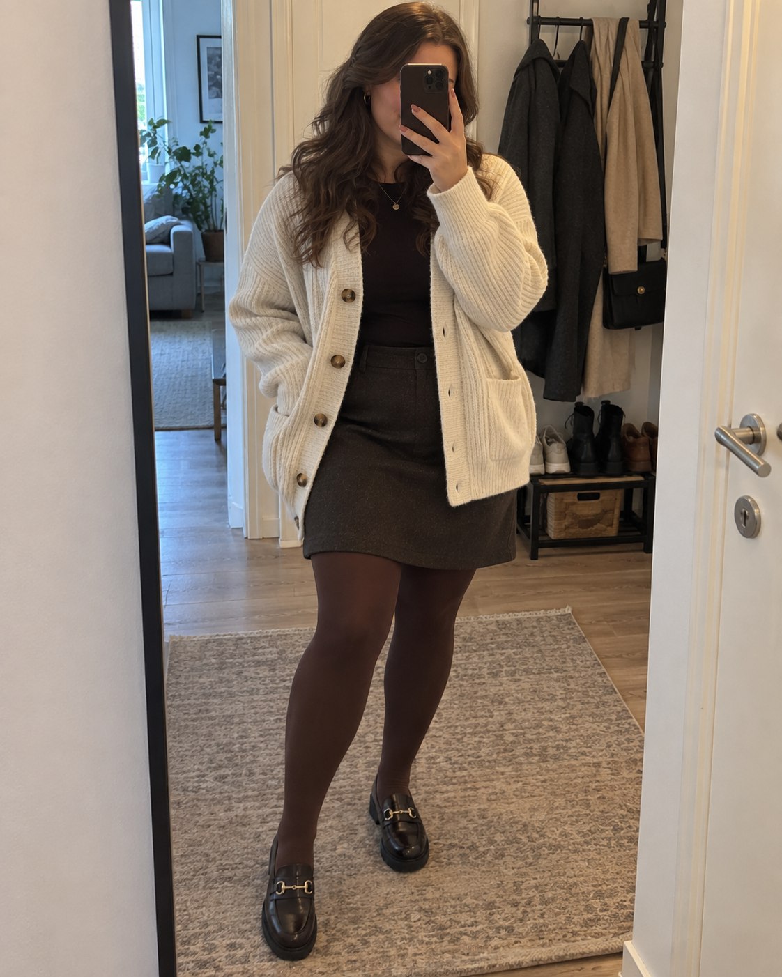 Customer mirror selfie styling cocoa tights with an ivory cardigan