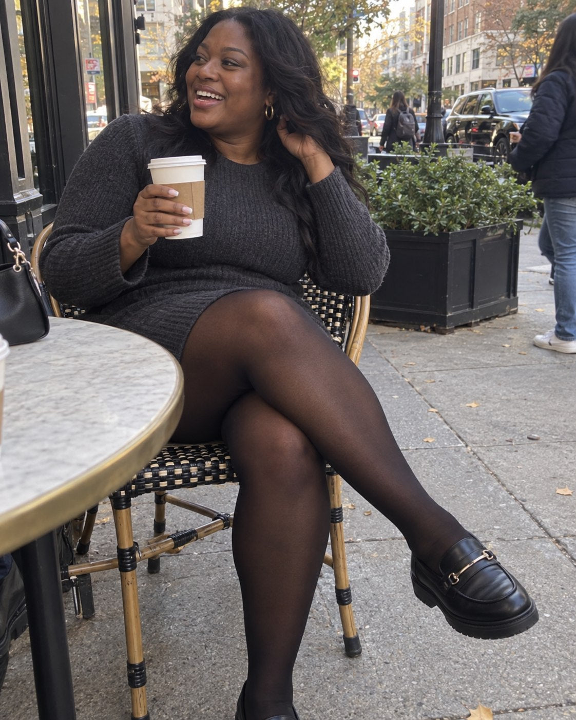 Customer wearing semi-sheer black tights at an outdoor café